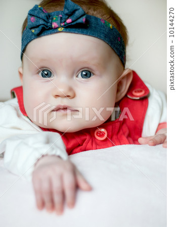 Little caucasian baby girl lying on her stomach 10144270