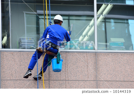 Wiping the window of the building 10144319