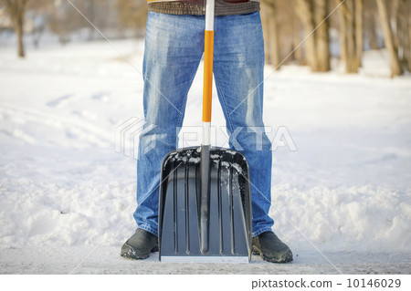 Man with a snow shovel on the trails 10146029