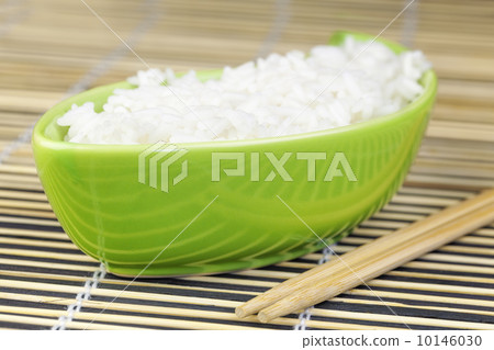 Rice in green clay bowl with wooden chopsticks 10146030