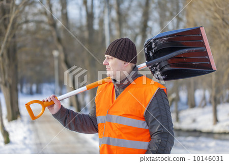 Man with a snow shovel on the sidewalk Man with a snow shovel on the sidewalk 10146031