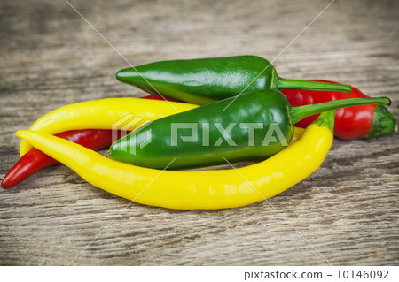 Different types of pepper on a wooden table Different types of pepper on a wooden table 10146092