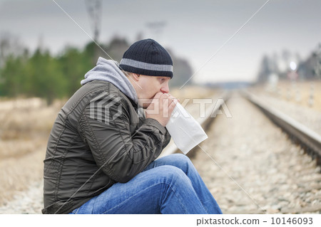Worried man breathe into a paper bag on a railway Worried man breathe into a paper bag on a railway 10146093