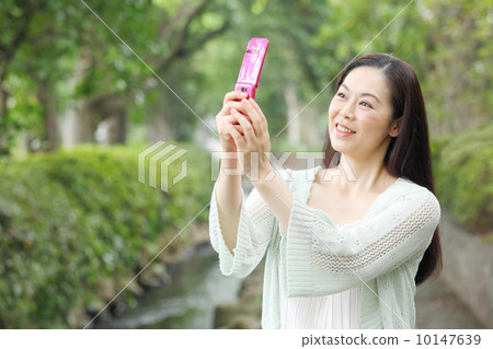A woman using a telephone A woman using a telephone 10147639