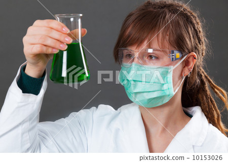 girl in a protective mask holding a flask 10153026