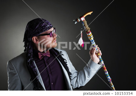 Shot of middle-aged man posing with decorated cane 10153354