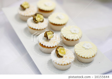 White vanilla cream cupcakes on a white plate White vanilla cream cupcakes on a white plate 10155644