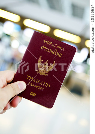 hand holding thailand passport 10156654