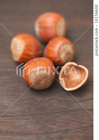 heap of hazelnuts on a wooden surface heap of hazelnuts on a wooden surface 10156688
