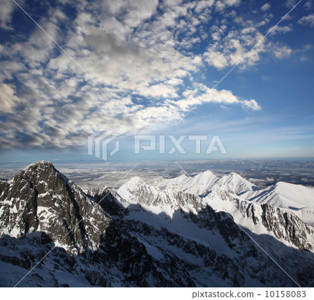 Amazing view of High winter Mountains against blue sky 10158083