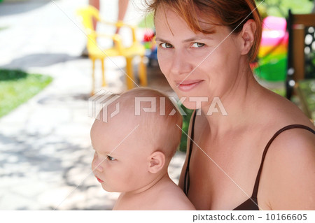Outdoor summer portrait of Young Caucasian mother and her baby 10166605