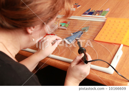 Stained glass maker works with small souvenirs 10166609