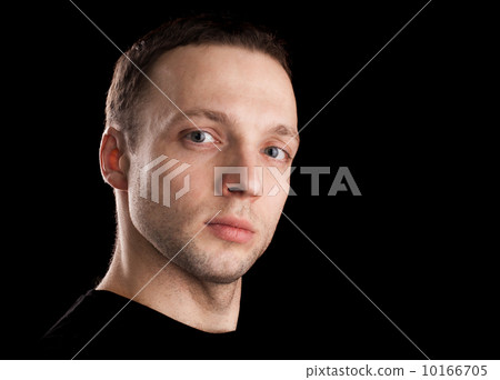 Proud young Caucasian man's portrait. Close-up face shoot isolated on black 10166705