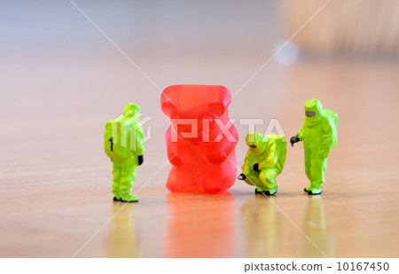 Group of people in protective suit inspecting a jelly bear 10167450