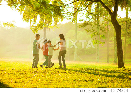 Happy asian family playing on the field 10174204