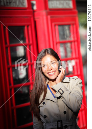 London woman on smartphone by red phone booth London woman on smartphone by red phone booth 10176341