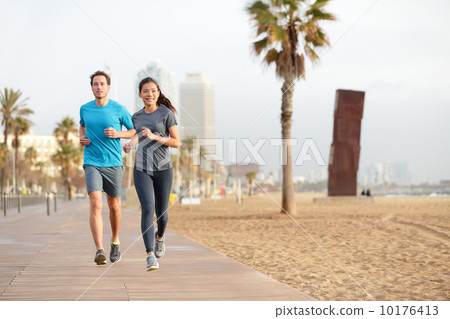 Running couple jogging Barcelona Beach Barceloneta Running couple jogging Barcelona Beach Barceloneta 10176413