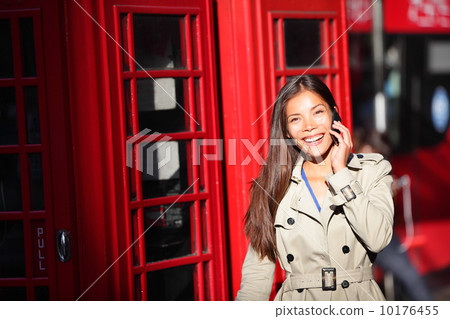 London woman on smart phone by red phone booth London woman on smart phone by red phone booth 10176455