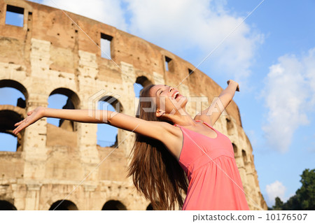 Happy carefree elated travel woman by Colosseum 10176507
