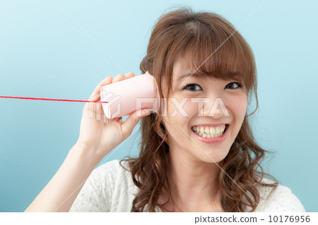 Young lady with red string phone 10176956