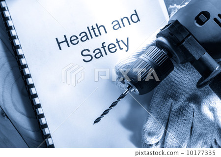 Drill and gloves on wooden background 10177335