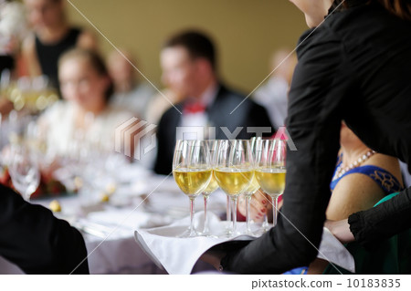 Waitress with dish of champagne glasses Waitress with dish of champagne glasses 10183835