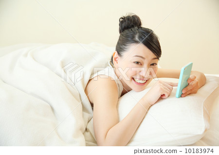 Woman using a smartphone Woman using a smartphone 10183974