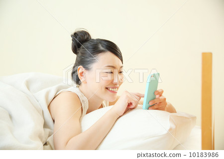 Woman using a smartphone Woman using a smartphone 10183986
