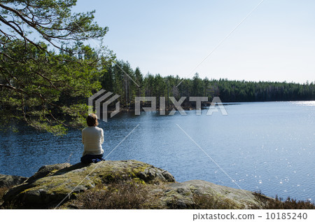 Woman at glittering forest lake 10185240