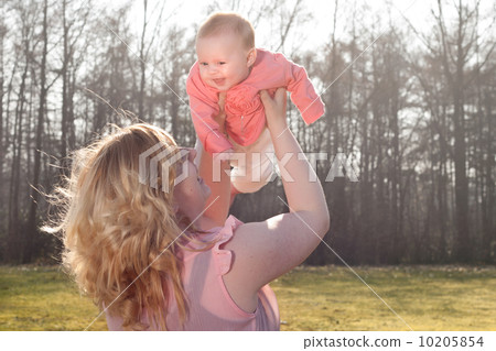 Baby flying in nature when mommy is holding her Baby flying in nature when mommy is holding her 10205854