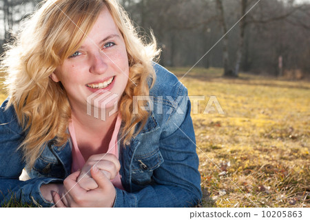Young smiling woman in the grass Young smiling woman in the grass 10205863