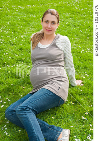 Beautiful pregnant woman relaxing in the park 10219776