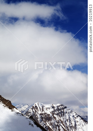 Winter snowy mountains and sky with clouds at sun day Winter snowy mountains and sky with clouds at sun day 10219913