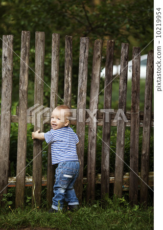 little boy with fence outdoors little boy with fence outdoors 10219954