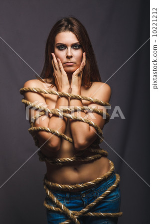 brunette hostage, captive bound woman with rope prisoner in jean 10221212