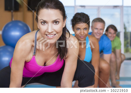 Interracial Group of Middle Aged People Practicing Yoga 10221910