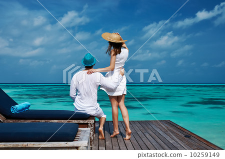 Couple on a beach jetty at Maldives 10259149