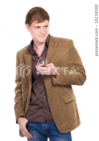Handsome man posing with a glass of whiskey Handsome man posing with a glass of whiskey 10259588