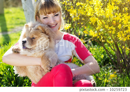 图库照片: girl with her dog on the nature