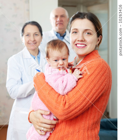 woman holding baby with doctors woman holding baby with doctors 10263416