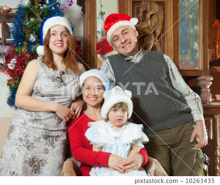family with girl posing for Christmas portrait 10263435