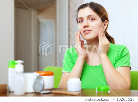 Smiing young woman puts cream 10263525