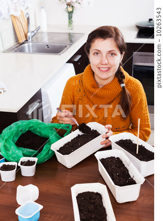 Girl sowing seeds in pots 10263543