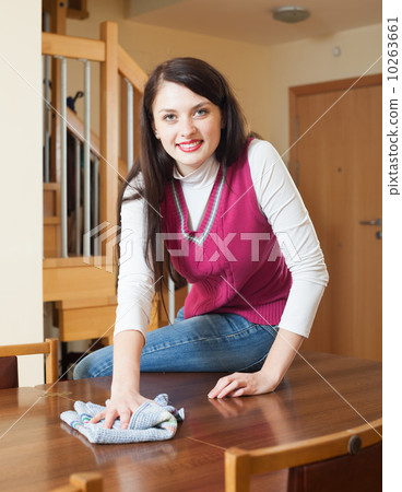 woman dusting wooden table 10263661