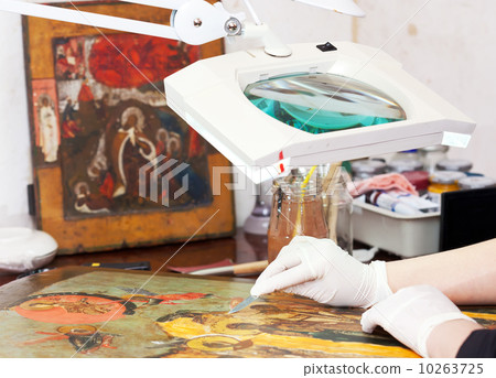 Closeup of Restorer working on the old icon Closeup of Restorer working on the old icon 10263725