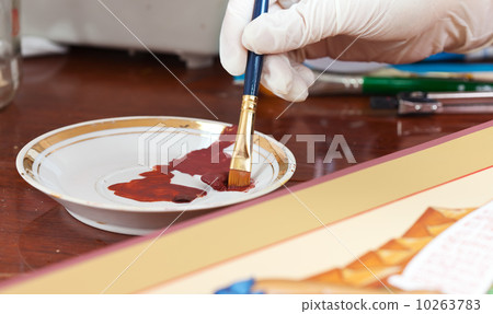 Artist works on new icon with brush Artist works on new icon with brush 10263783