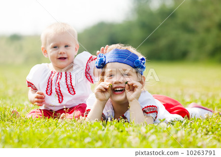 children in folk clothes on grass children in folk clothes on grass 10263791