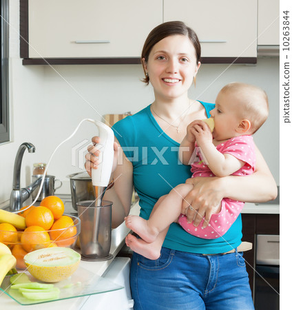 Happy woman with baby  in kitchen 10263844
