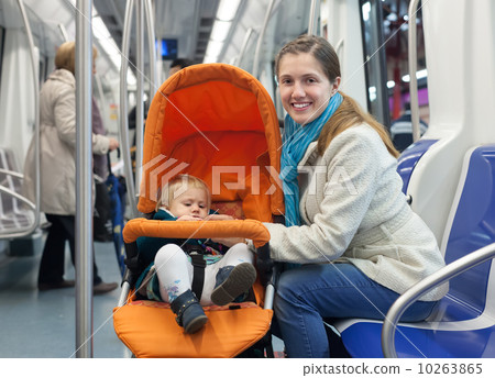 mother with baby in stroller inside metro 10263865