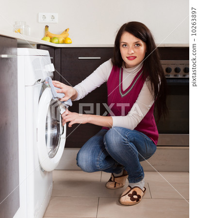 brunette woman cleaning washing machine brunette woman cleaning washing machine 10263897